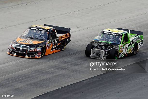 Jason White, driver of the GunBroker.com Dodge, races Brett Butler, driver of the Fuel Doctor Chevrolet, side by side during the NASCAR Camping World...