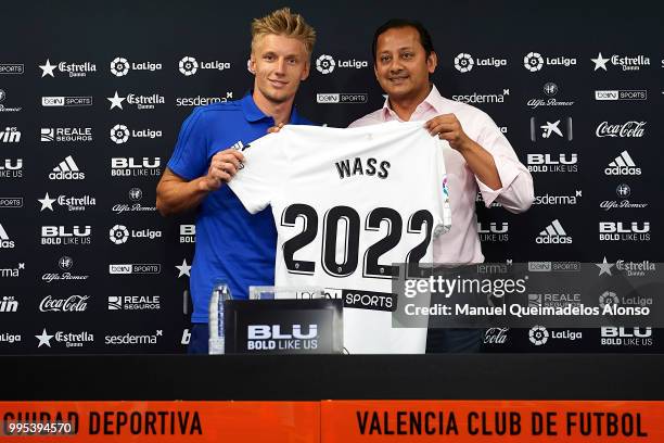 Anil Murthy president of Valencia CF and Daniel Wass pose during his presentation as a new player for Valencia CF at Paterna Training Centre on July...