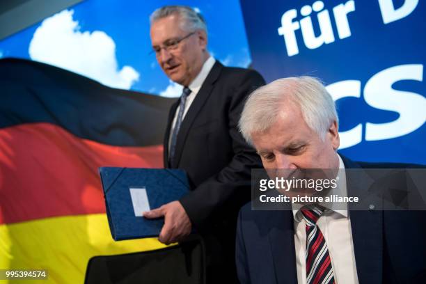 Bavarian premier Horst Seehofer and Bavarian interior minister Joachim Herrmann attend a meeting of the CSU leadership in Munich, Germany, 25...