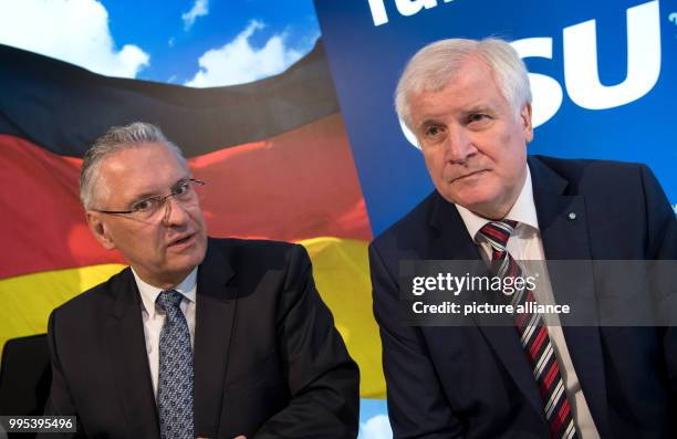 Bavarian premier Horst Seehofer and Bavarian interior minister Joachim Herrmann attend a meeting of the CSU leadership in Munich, Germany, 25...