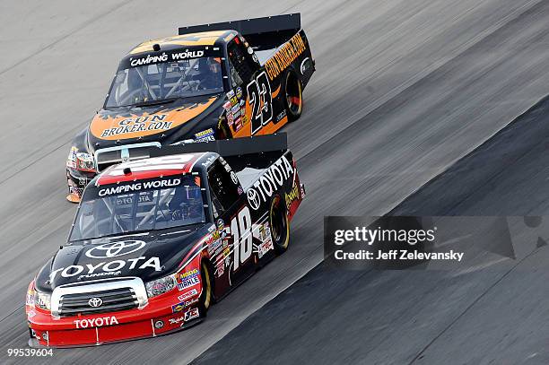 Kyle Busch drives the Toyota Tundra Toyota ahead of Jason White, driver of the GunBroker.com Dodge, during the NASCAR Camping World Truck Series...