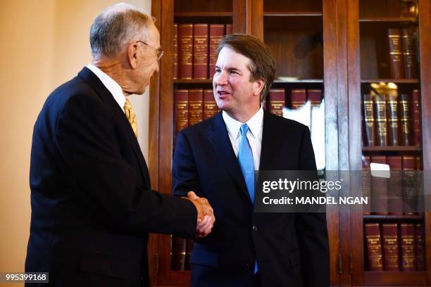 Senate Judiciary Committee Chairman Chuck Grassley shakes hands with Supreme Court associate justice nominee Brett Kavanaugh in the US Capitol in...