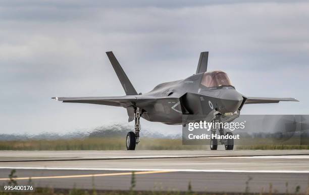 In this handout image provided by the Ministry of Defence, an Royal Air Force F-35 Lightning from 617 Sqn taking off from RAF Marham to join the...