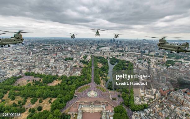 In this handout image provided by the Ministry of Defence, Royal Air Force Chinooks from RAF Odiham flew in the lead formation, along with Pumas from...