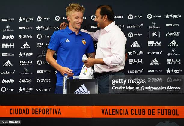 Anil Murthy president of Valencia CF and Daniel Wass pose during his presentation as a new player for Valencia CF at Paterna Training Centre on July...