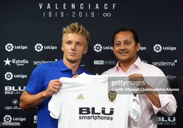 Anil Murthy president of Valencia CF and Daniel Wass pose during his presentation as a new player for Valencia CF at Paterna Training Centre on July...