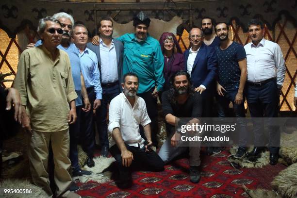 Venezuelan President Nicolas Maduro and his wife Cilia Flores pose for a photo with the actors as they visit the set of famous Turkish TV show...