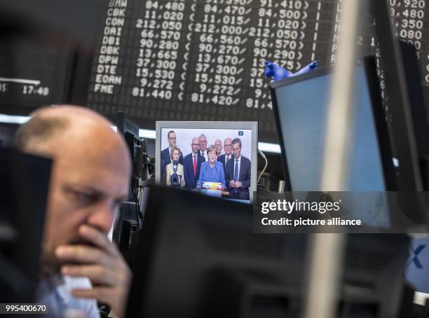 Dpatop - Angela Merkel is visible on a screen in the Frankfurt Stock Exchange in Frankfurt/Main, Germany, 25 September 2017. The German leading index...