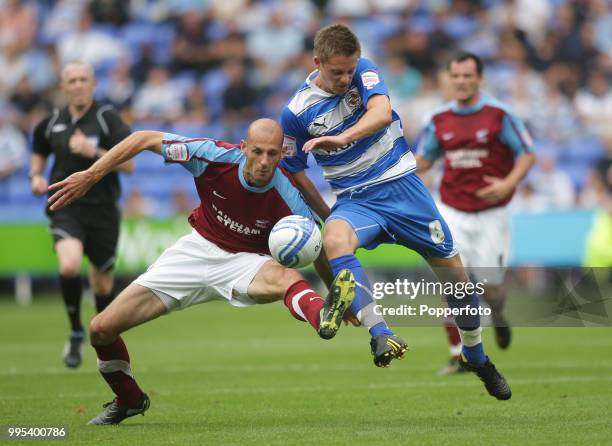 Gylfi Sigurdsson of Reading tangles with Rob Jones of Scunthorpe United during an Npower Championship match at the Madejski Stadium on August 7, 2010...