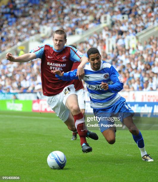 Jobi McAnuff of Reading tangles with Eddie Nolan of Scunthorpe United during an Npower Championship match at the Madejski Stadium on August 7, 2010...