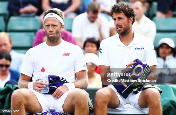 Robin Haase of the Netherlands and Robert Lindstedt of Sweden take a drink between games against Dominic Inglot of Great Britain and Franko Skugor of...