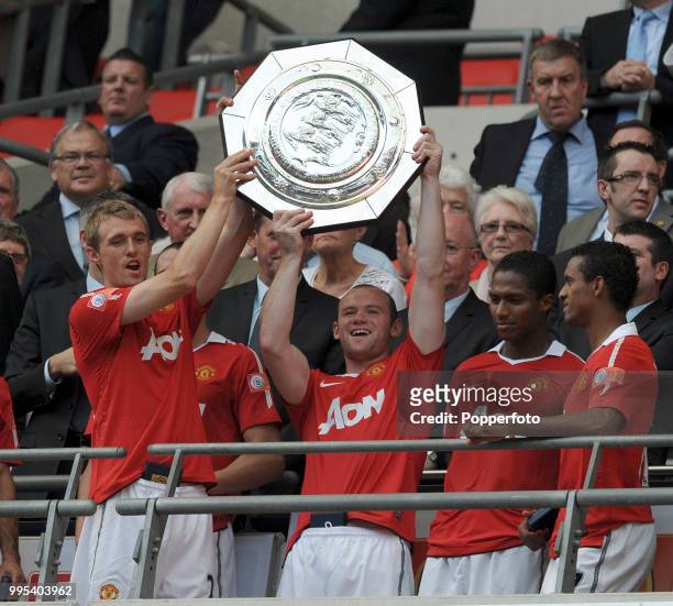 Darren Fletcher and Wayne Rooney of Manchester United lift the trophy after the FA Community Shield between Chelsea and Manchester United at Wembley...