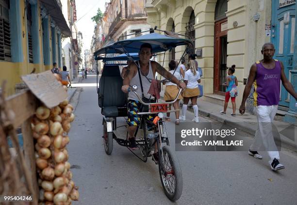 Pedicab driver looks for clients in a street of Havana on June 10, 2018. - Cuba gave Tuesday a new green light to private work, after a setback of...