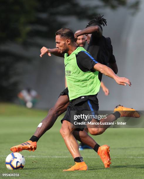 Danilo D'Ambrosio is challenged by Yann Karamoh during the FC Internazionale training session at the club's training ground Suning Training Center in...