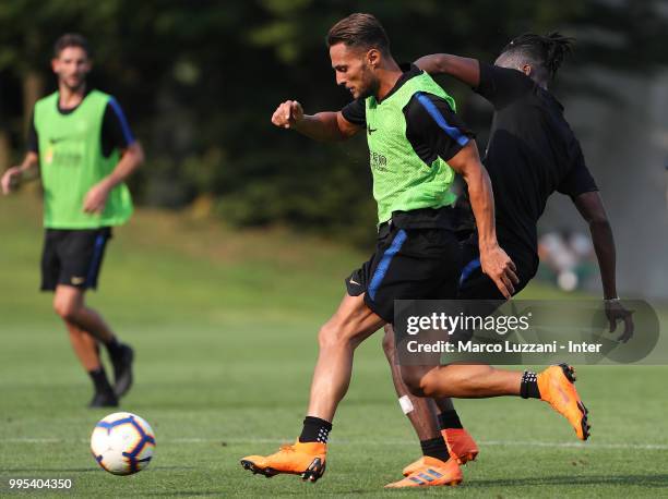 Danilo D'Ambrosio is challenged by Yann Karamoh during the FC Internazionale training session at the club's training ground Suning Training Center in...