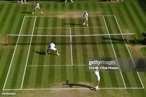 Robin Haase of the Netherlands and Robert Lindstedt of Sweden compete against Dominic Inglot of Great Britain and Franko Skugor of Croatia during...