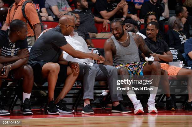 Assistant Coach Sam Cassell of the LA Clippers and John Wall of the the Washington Wizards exchange handshakes during the game between the the...