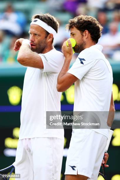 Robin Haase of the Netherlands and Robert Lindstedt of Sweden talk tactics against Dominic Inglot of Great Britain and Franko Skugor of Croatia...