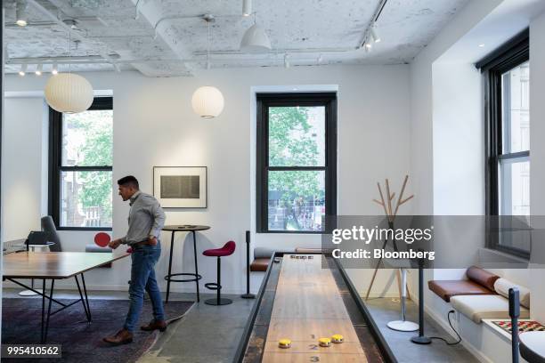 Member plays ping pong in the game room of the Convene workspace flagship location in New York, U.S., on Monday, July 2, 2018. Convene, a New...