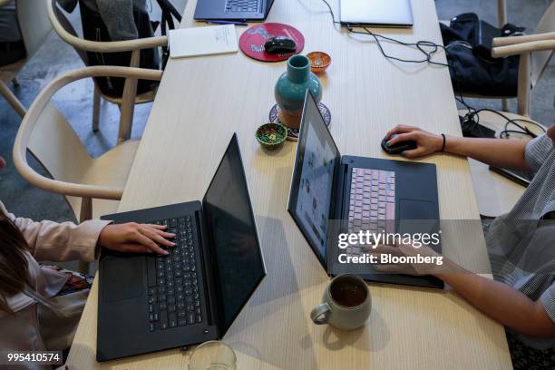 Members work on laptop computers at the Convene workspace flagship location in New York, U.S., on Monday, July 2, 2018. Convene, a New York-based...