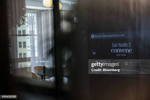 Monitor displays signage at the Convene workspace flagship location in New York, U.S., on Monday, July 2, 2018. Convene, a New York-based real estate...