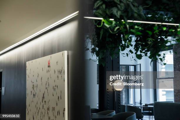 Seating area is reflected in a mirror at the Convene workspace flagship location in New York, U.S., on Monday, July 2, 2018. Convene, a New...