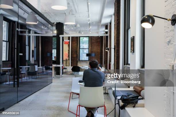 Member speaks on a mobile device at the Convene workspace flagship location in New York, U.S., on Monday, July 2, 2018. Convene, a New York-based...