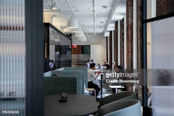 Members sit and work at the Convene workspace flagship location in New York, U.S., on Monday, July 2, 2018. Convene, a New York-based real estate...