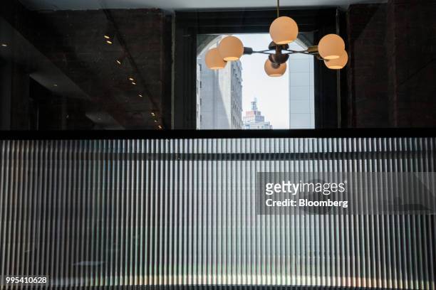 Lamp hangs from the ceiling at the Convene workspace flagship location in New York, U.S., on Monday, July 2, 2018. Convene, a New York-based real...
