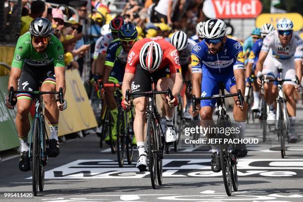 Colombia's Fernando Gaviria , Slovakia's Peter Sagan and Germany's Andre Greipel after crossing the finish line to respectively place first, second...