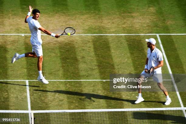 Dominic Inglot of Great Britain and Franko Skugor of Croatia compete against Robin Haase of the Netherlands and Robert Lindstedt of Sweden during...