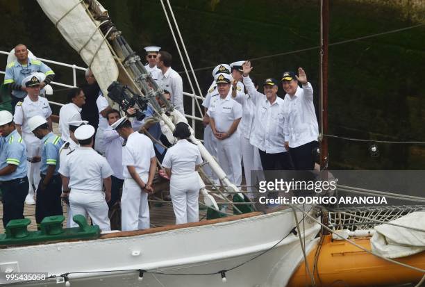 Panama's President Juan Carlos Varela and his Chilean counterpart Sebastian Pinera wave on board Chilean School Ship Esmeralda at Miraflores Lock in...