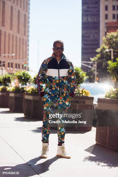 Guest in a floral tracksuit and Yeezy sneakers during New York Fashion Week Mens Spring/Summer 2019 on July 9, 2018 in New York City.