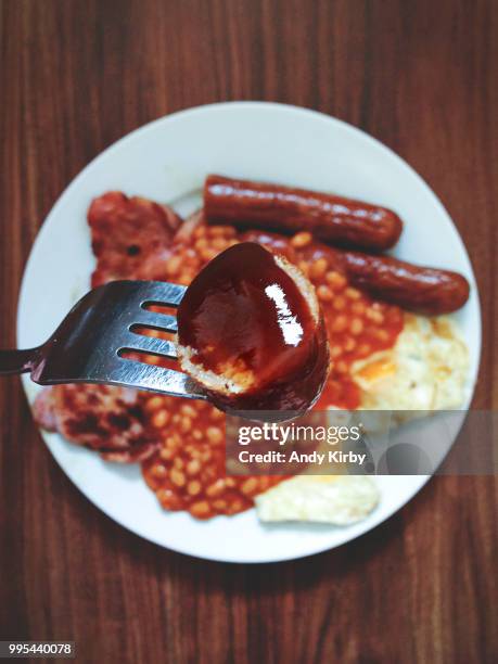 brown sauce on a sausage and a breakfast meal. - brown sauce foto e immagini stock