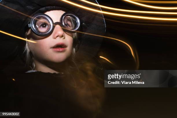girl with sparkler wearing flying goggles, long exposure - flying goggles imagens e fotografias de stock