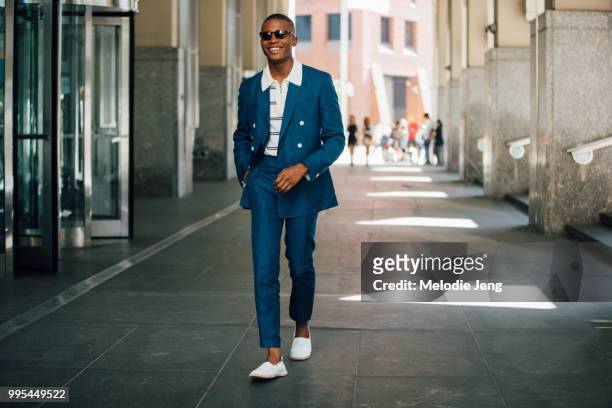Igee Okafor wears a Sandro Homme blue suit and Institchu shirt during New York Fashion Week Mens Spring/Summer 2019 on July 9, 2018 in New York City.