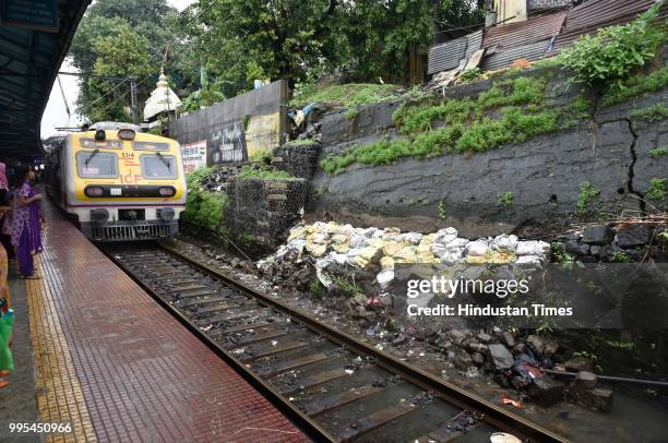 Wall colapse adjacent to railway track at Sandhurst Road railway station on July 9, 2018 in Mumbai, India. Indias financial capital and its...