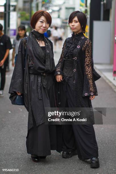Hiroko and Kure Ha stop for a fashion snap on July 08, 2018 in Harajuku, Tokyo, Japan. Hiroko, an office worker, is wearing H,Naoto and carrying a...