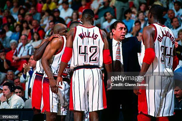 Head coach Rudy Tomjanovich speaks to Hakeem Olajuwon and Kevin Willis of the Houston Rockets in the huddle against the Utah Jazz in Game Four of the...