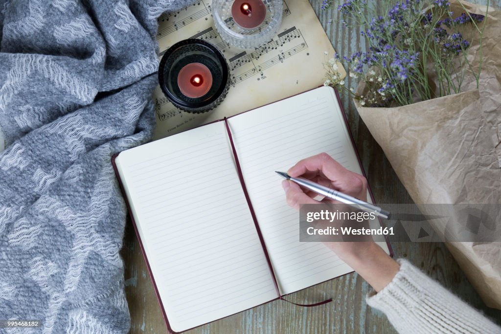 Hand of woman writing in notebook