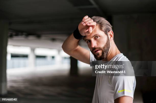 portrait of athlete in parking garage with sweatband - sweat band stock pictures, royalty-free photos & images