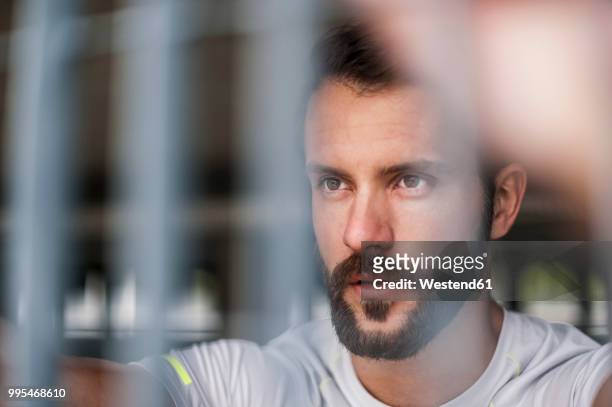portrait of confident athlete behind grid - human face people grid stock pictures, royalty-free photos & images