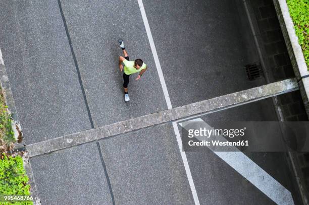 top view of man running on a street - asphalt von oben stock-fotos und bilder