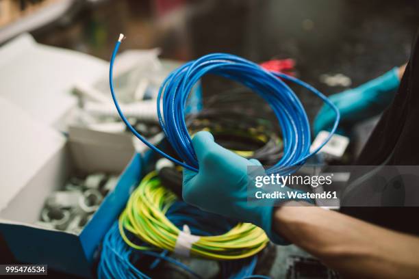 detail of a man holding a roll of electric cable - cable installer stock pictures, royalty-free photos & images