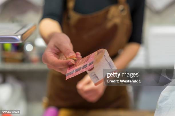 butchery, female butcher with change - paying cash stock pictures, royalty-free photos & images