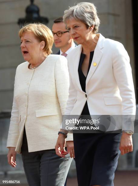 German chancellor Angela Merkel and Prime Minister Theresa May are seen during a press conference with Polish Prime Minister Mateusz Morawiecki...