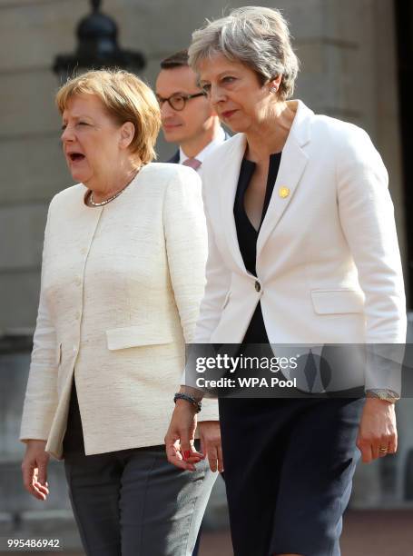 German chancellor Angela Merkel and Prime Minister Theresa May are seen during a press conference with Polish Prime Minister Mateusz Morawiecki...