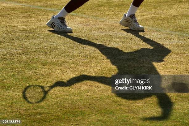 Brazil's Joao Lucas Reis da Silva serves as he plays doubles with Brazil's Matheus Pucinelli De Almeida on the eighth day of the 2018 Wimbledon...