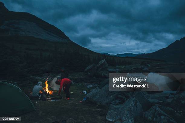 norway, lofoten, moskenesoy, young men camping at selfjord - moskenesoya stock pictures, royalty-free photos & images