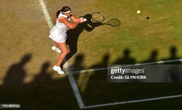 France's Marion Bartoli returns in her doubles match with Slovakia's Daniela Hantuchova on the eighth day of the 2018 Wimbledon Championships at The...